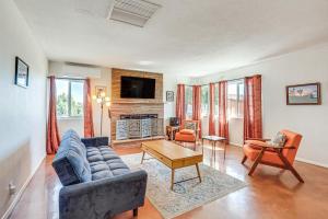 a living room with a couch and a tv at Twentynine Palms Harmonic House with Mtn Views! in Twentynine Palms