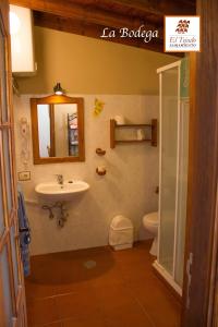a bathroom with a sink and a toilet and a mirror at Alojamientos El Tejado in Buenavista del Norte
