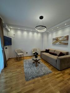 a living room with a couch and a table at HelVik Apartman Aqua Park in Vrnjačka Banja