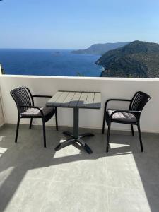 a table and two chairs on a balcony with the ocean at Aelia Studio Alonissos in Alonnisos