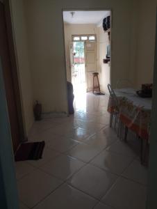a room with a table and a table and a door at Casa quarto dormitório estudantil em salobrinho para uescquianos in Ilhéus