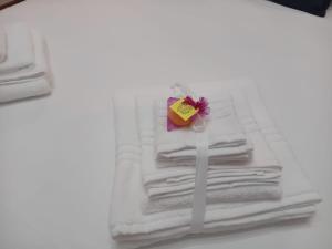 a pile of towels with a box on top of them at Antico Palazzo in Salerno