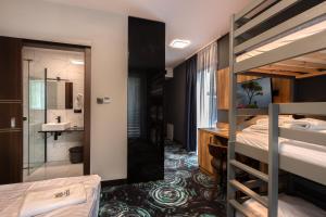 a room with two bunk beds and a bathroom at Willa Pieńkowskich in Gdynia