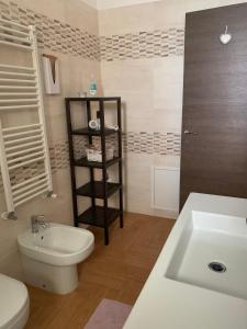 a bathroom with a white toilet and a sink at Al Civico 49 in Campobasso +30 photos