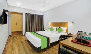 a hotel room with a large bed and a desk at Olive Home Stay in Agra