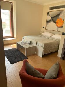 a bedroom with a bed and a couch in a room at Al Civico 49 in Campobasso