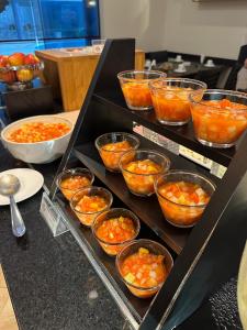 a bunch of bowls of food on a table at Hotel Saint Paul in Sao Jose do Rio Preto