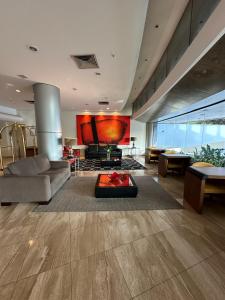 a living room with a couch and a fireplace at Hotel Saint Paul in Sao Jose do Rio Preto