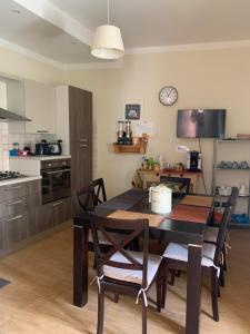 a kitchen with a table and chairs in a room at Al Civico 49 in Campobasso