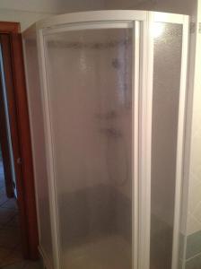 a shower with a glass door in a bathroom at Casa Osti in Spormaggiore +9 photos