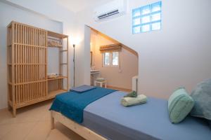 a bedroom with a blue bed in a room at Olive Treasure Villa with Private Pool in Kolymbia +49 photos