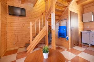 a room with a wooden staircase in a cabin at Raj nad Morzem in Bobolin