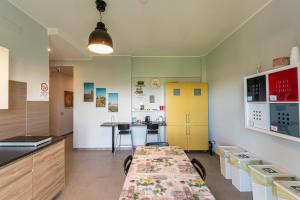 a kitchen with a long table and a yellow cabinet at FARE BnB - Room del Parco in Reggio Emilia