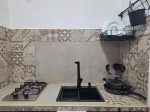 a kitchen counter with a stove and a sink at Prince Airport House in Catania