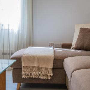 a living room with a couch and a glass table at Stunning 1-Bed Apartment In Heart of Valletta in Valletta