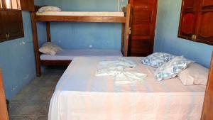 Cama ou camas em um quarto em Caminhos do Mar Hostel