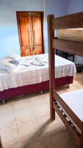 Cama ou camas em um quarto em Caminhos do Mar Hostel