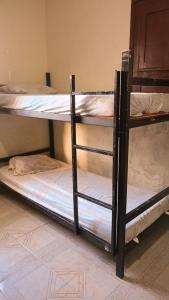 Cama ou camas em um quarto em Caminhos do Mar Hostel