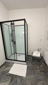 a glass shower in a room with a tile floor at Penzion Slovácko 2 in Ostrožská Nová Ves