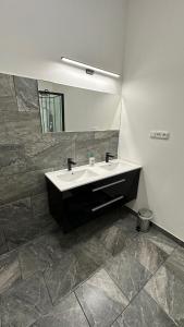 a bathroom with a sink and a mirror at Penzion Slovácko 2 in Ostrožská Nová Ves +3 photos