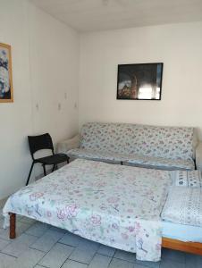 a bedroom with a bed and a chair in it at Suite Praias Penha SC in Penha