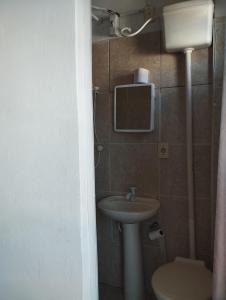 a bathroom with a sink and a toilet at Suite Praias Penha SC in Penha