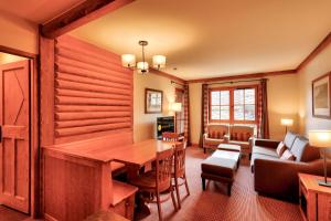 a living room with a wooden table and a couch at Résidence Les Arcs 1950 Le Village - maeva Home - Appartement 2 pièces 4 personnes - Prestige MAE-2911 in Arc 1950