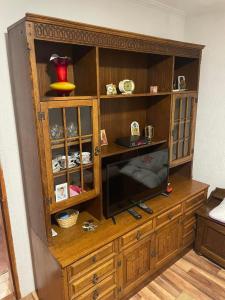 a wooden entertainment center with a television in it at Vikendica Vukovic in Foča