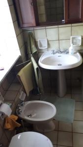 a small bathroom with a sink and a toilet at Casa nel verde !!! in Falconara Albanese +38 photos