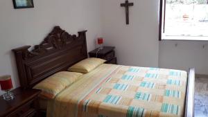 a bed with two pillows on it in a bedroom at Casa nel verde !!! in Falconara Albanese