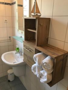 a bathroom with a sink and a toilet and a mirror at Kompassrose in Prerow