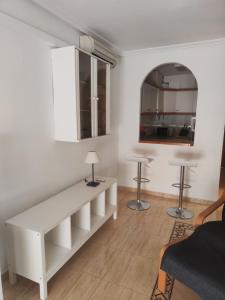 a living room with a white table and two stools at Casa Marius in La Mata