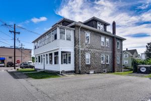 an old brick house on the corner of a street at Pet-Friendly Stoughton Apartment with Outdoor Space in Stoughton