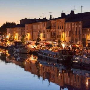 a group of boats docked in a marina at night at Evasion dépaysante Canal du Midi La vie en couleur in Castelnaudary