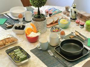 a table topped with a table with food and utensils at WhiteHome in Conegliano +32 photos