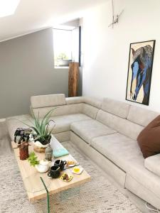 a living room with a white couch and a coffee table at WhiteHome in Conegliano