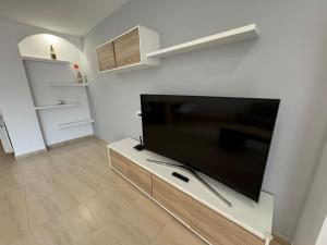 a living room with a large flat screen tv at Costapera in La Pobla de Segur