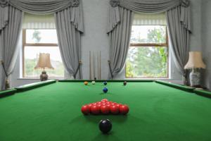 a room with a pool table with balls on it at Tre-Ysgawen Hall & Spa in Llangefni