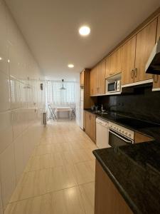 a kitchen with wooden cabinets and a counter top at Costapera in La Pobla de Segur
