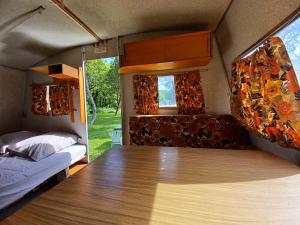 a room with a bed and a table in a caravan at Caravane vintage in Pornichet