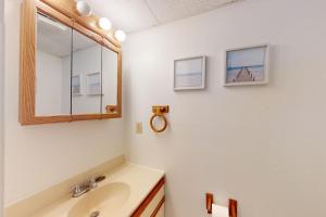 a bathroom with a sink and a mirror at Marathon North 101 in Ocean City