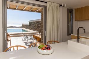a kitchen with a table with a bowl of fruit at casa eterna in Agios Romanos
