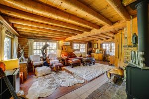 a large living room with wooden ceilings and furniture in a cabin at Pine Mountain Club Log Cabin with Resort Amenities! in Pine Mountain Club