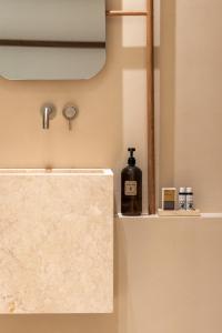 a bottle of wine sitting on a shelf in a bathroom at casa eterna in Agios Romanos +50 photos