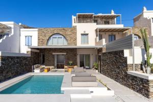 a villa with a swimming pool and a house at casa eterna in Agios Romanos