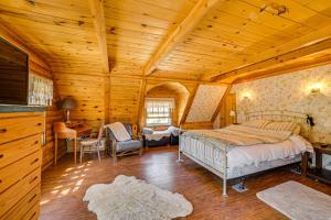 a bedroom with a bed and a wooden ceiling at Pine Mountain Club Log Cabin with Resort Amenities! in Pine Mountain Club
