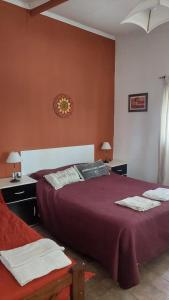 a bedroom with two beds and two tables with lamps at La Nilda in Tandil +15 photos