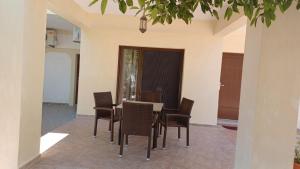 a dining room with a table and chairs at Tsanis in Parga
