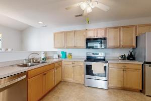 a kitchen with wooden cabinets and stainless steel appliances at The Reserves of Nassau - 17295 Queen Anne Way in Lewes