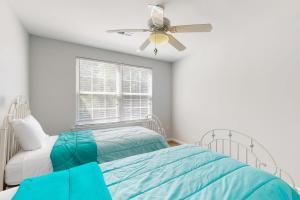 a bedroom with a bed and a ceiling fan at The Reserves of Nassau - 17295 Queen Anne Way in Lewes
